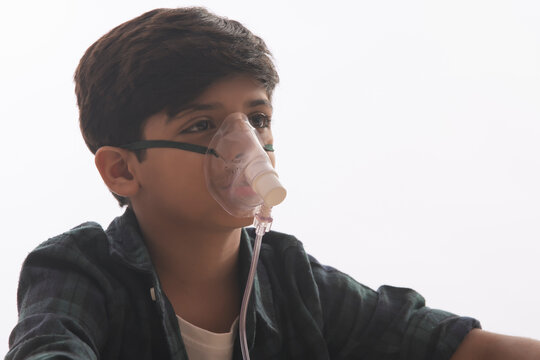 Young boy with asthma problems making inhalation with mask on his face.(Children) 