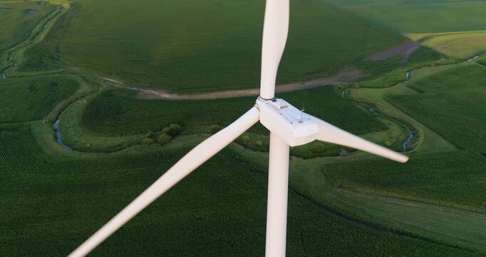 Aerial view of a wind turbine set against vast green cornfields in rural Gardner, Illinois, United States.