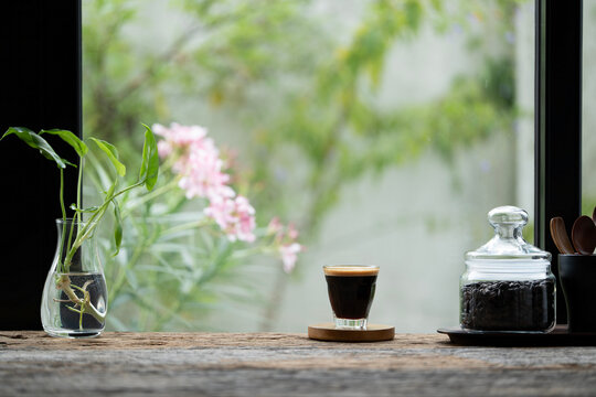 Coffee glass cup and coffee beans in a glass vase