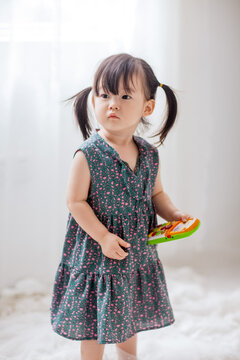 Cute Asian little girl playing indoors