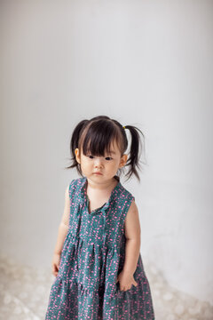 Cute Asian little girl playing indoors