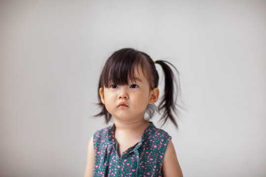 Cute Asian little girl playing indoors