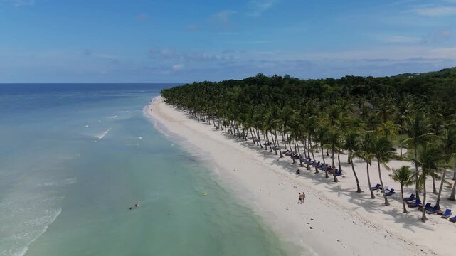 Aerial view of Dumaluan Beach with white sand, turquoise water, and palm trees in Panglao, Central Visayas, Philippines.