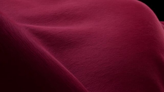 Deep burgundy fabric settling over smooth forms with gentle fold smoothing, rounded contours, soft texture, and shifting highlights under directional studio light