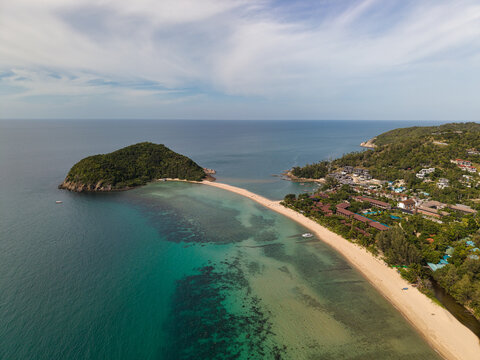 Aerial view of Ko Pha Ngan with its sandy beach, turquoise waters, and lush tropical greenery in Ko Pha-ngan District, Surat Thani, Thailand.