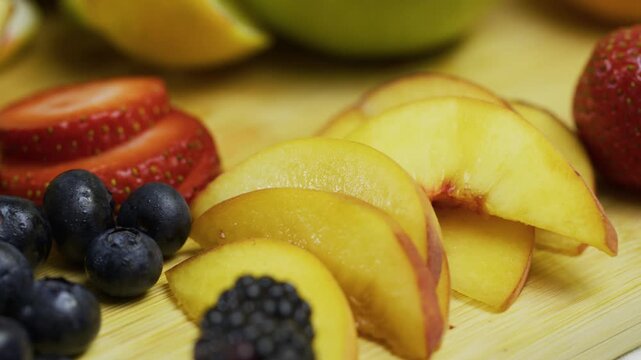 Panning closeup shot across fresh sliced and whole fruit on counter
