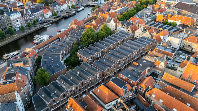 Aerial view of the historic city center with its characteristic orange rooftops, narrow streets, and a canal flowing through the urban landscape in Zwolle, Overijssel, Netherlands.