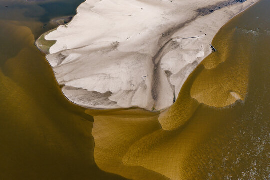 Aerial view of a large sandbank in a river caused by low water levels in Poland.