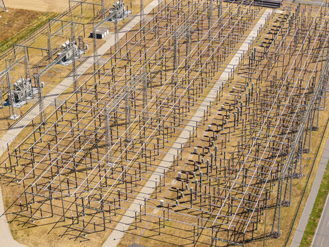 Aerial view of the Amprion-Umspannwerk electrical substation featuring complex metal structures, power lines, and transformers in Pfungstadt, Hessen, Germany.