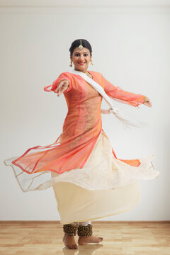 Beautiful kathak dancer circling at home.