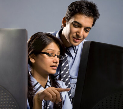 Boy and girl looking at a computer