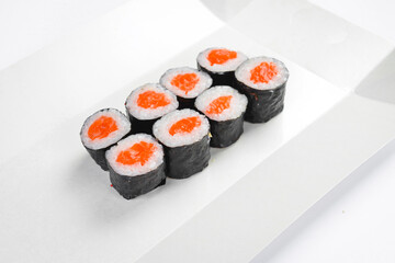 Classic Japanese salmon hosomaki sushi roll set served in white paper takeaway tray. Fresh rolls filled with raw salmon wrapped in nori. Delicious seafood meal. © Yaruniv-Studio