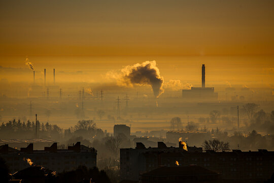 Aerial view of industrial smog and pollution hanging over the urban skyline and chimneys of Turin, Piedmont, Italy.
