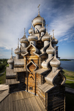 Aerial view of the historic Kizhi Pogost wooden church with its iconic multiple onion domes and intricate timber architecture on the shores of Lake Onega in Petrozavodsk, Republic of Karelia, Russia.