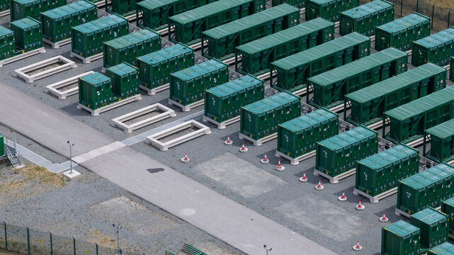 Aerial view of the Thurrock Flexible Generation Substation featuring rows of green battery energy storage containers on a gravel site in Tilbury, England, United Kingdom.