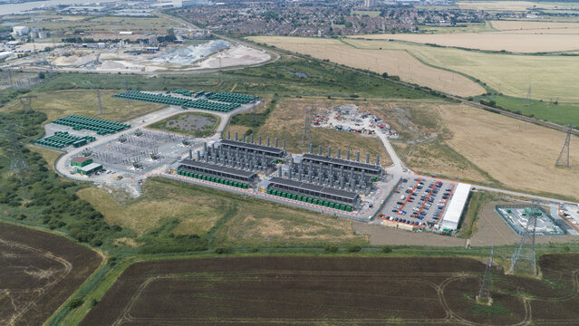 Aerial view of Thurrock Flexible Generation Substation with power generation units, battery storage containers, and electrical infrastructure in Tilbury, England, United Kingdom.