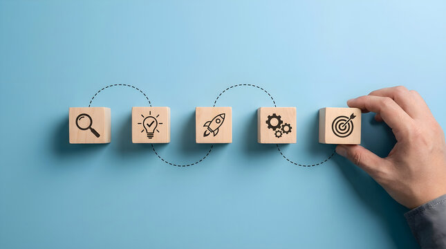 Business Strategy Concept Hand Placing Wooden Blocks with Icons on Blue Background