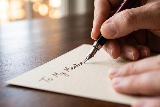 Close-up of student writing a mentor appreciation card with fountain pen