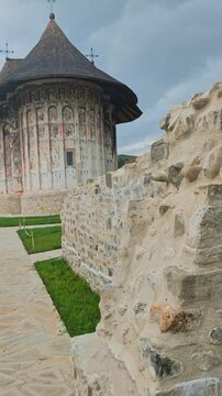 Historic Humor Monastery with unique exterior frescoes, an iconic UNESCO World Heritage site surrounded by nature in Bucovina, Romania.