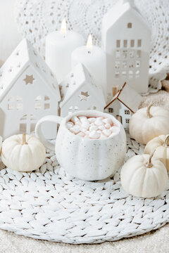 autumn background. Cozy Autumn Hot Chocolate with Mini Pumpkins and Fall Decor Warm mug of hot chocolate with mini marshmallows, white pumpkins and home decor. Inviting autumn scene
