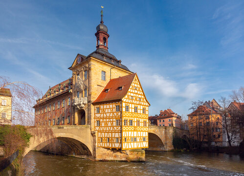 View of the historic City Hall, traditional buildings and the Regnitz River in the center of Bamberg, Bavaria, Germany.
