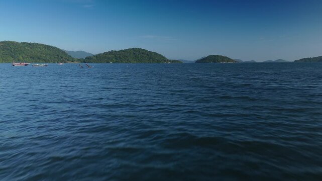 Fast flight forward over the water surface towards the small islands in the sea. Area near the town of Angra dos Reis and the island of Ilha Grande in Brazil