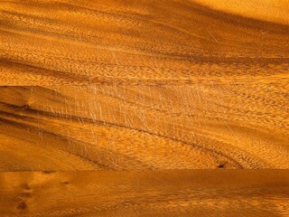Fototapeta premium Scratched wooden surface texture background with warm natural grain