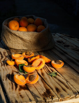 Fresh ripe apricots on a rustic wooden table. Organic summer fruit with copy space.