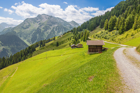 The road between the Penken ropeway and the Finkenberger Almbahnen with alpine pastures and the Tristner Mountain