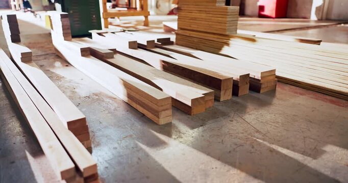 Carpentry, lumber and material in empty factory for craftsmanship, manufacturing or production. Creativity, industry and timber with wood in warehouse interior for furniture business or storage