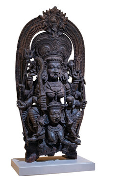 Detailed carved wooden statue of Hindu deity Chamunda with multiple arms and traditional iconography isolated on a white background.