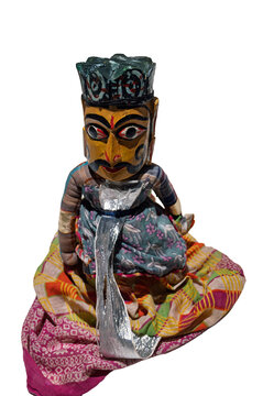 Traditional Kathputli Indian string puppet dressed in colorful fabric isolated on a white background.