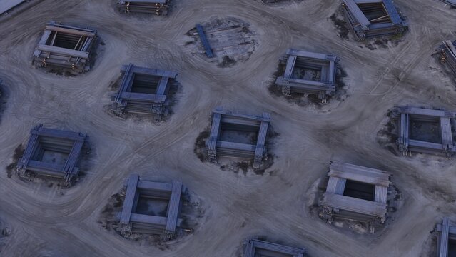 Aerial view of organized stacks of steel ingots arranged in a grid pattern on a dirt yard at a steel mill in Monroe, Michigan, United States.