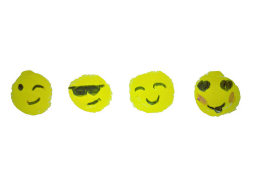 Hand drawn yellow smiley face emojis on paper