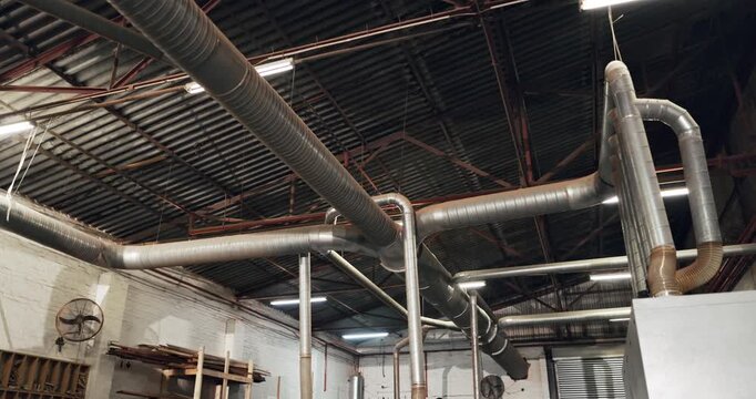 Background, industry and pipes in empty warehouse for manufacturing, production or ventilation. Air flow, interior and metal with ac setup in factory or plant for commercial distribution or storage