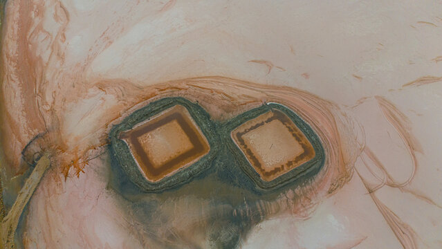 Aerial view of Koyuncu Salt Works with pink salt evaporation ponds in Sereflikochisar, Ankara, Turkiye.