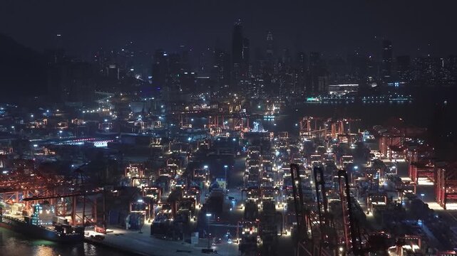 Unloading large cargo containers seaport. Loading freight sea port. Top aerial drone view. Lot big boxes rows, ship delivery ocean harbor. Shipping night. Goods export import. Industrial Marine dock.