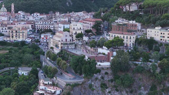 Aerial view of the coastal town of Vietri sul Mare with historic buildings, lush trees, and winding roads in Vietri sul Mare, Salerno, Campania, Italy.
