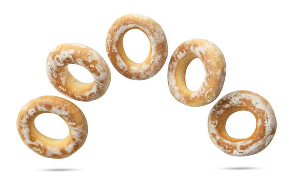 Dry bagels flying close-up on a white. Isolated