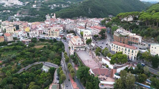 Aerial view of the coastal town of Vietri sul Mare with its historic church and amphitheater surrounded by lush green hills in Vietri sul Mare, Salerno, Campania, Italy.