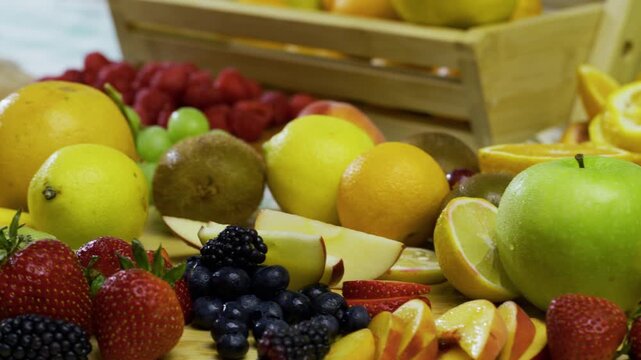 Sliced and whole fruit scattered across kitchen counter - tracking shot