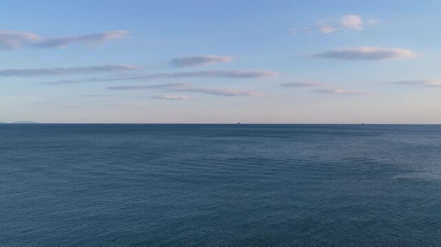Aerial view of the calm sea with concrete breakwater blocks along the sandy shore in Vietri sul Mare, Salerno, Campania, Italy.