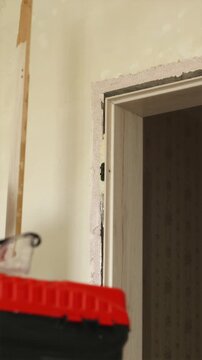 Removing door frame trim moulding with pry bar close up