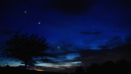 Crescent Moon, planet conjunction and landscape scenery silhouettes. © astrosystem