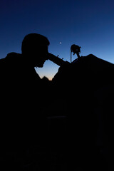 Amateur astronomer observing stars, planets, Moon and other celestial objects with a telescope in nature. © astrosystem