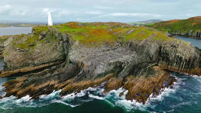 Aerial view of baltimore beacon standing on cliff top overlooking atlantic ocean in county cork of ireland.