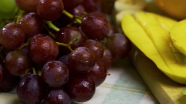 Extra closeup on delicious, wet fruit scattered on counter - tracking shot