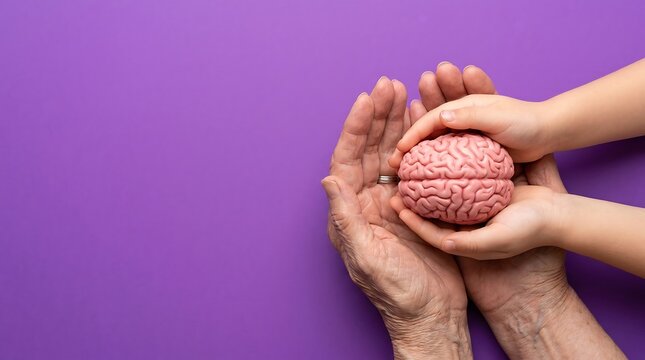 World Alzheimers Day Concept with Child and Elderly Hands Holding Brain