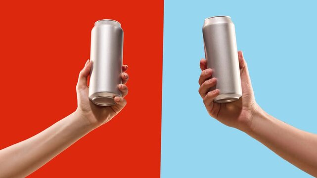 Hands holding blank aluminum beverage cans on changing colorful background in stop motion. Concept of beverage packaging mockup, product advertising, brand presentation.