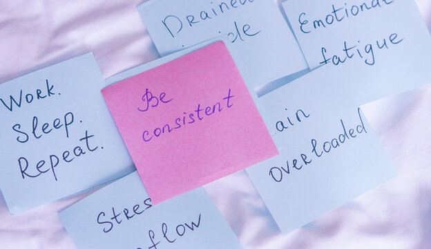 Pink and blue sticky notes featuring handwritten messages about consistency, emotional fatigue, and mental health motivation